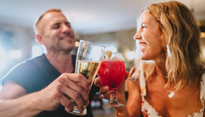 A happy couple toasting drinks at Gideon Putnam Hotel