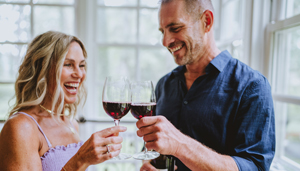 A couple toasting wine glasses at Gideon Putnam