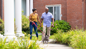 A couple walking their dog outside Gideon Putnam