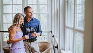 A couple toasting wine glasses at Gideon Putnam